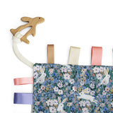Wooden teether rabbit attached to a taggy blanket with matching ribbons and rabbit floral design