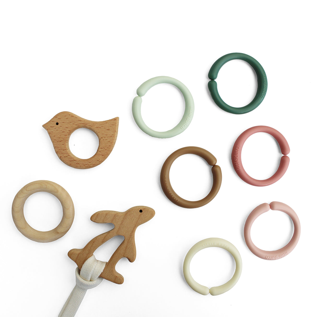 Set of wooden baby teething rings in various shapes and colours on a white background