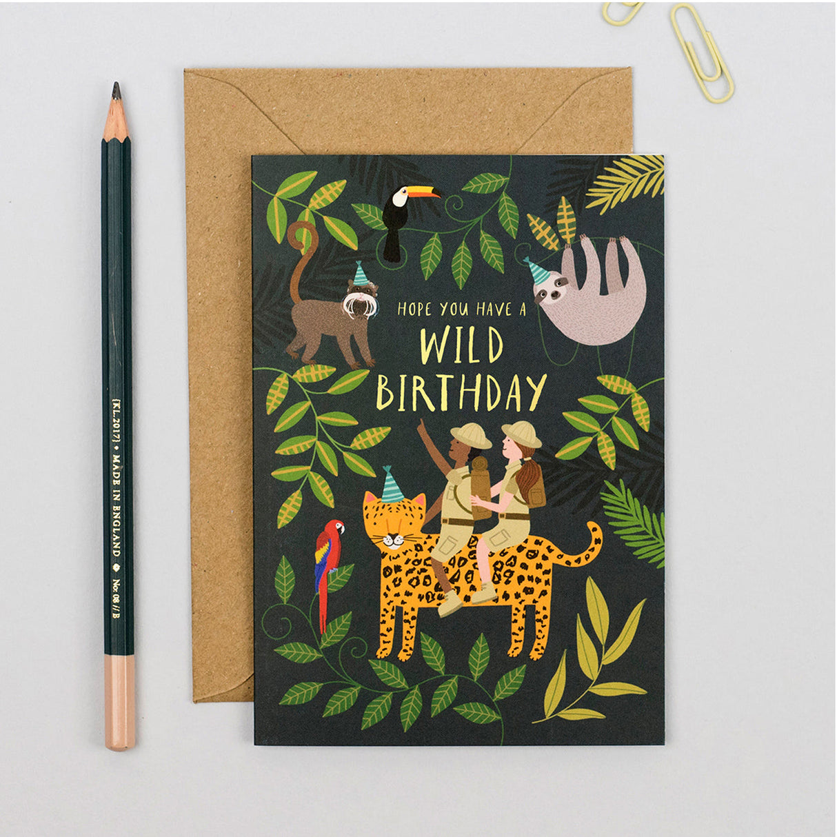 Greeting card with jungle-themed illustration and envelope on a light gray background