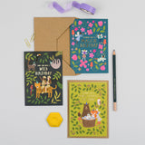 Three colourful birthday cards with envelopes on a light gray background