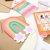Close-up of Mifkins Rainbow Blossom Birthday Card showing rainbow arch and smiling flower details