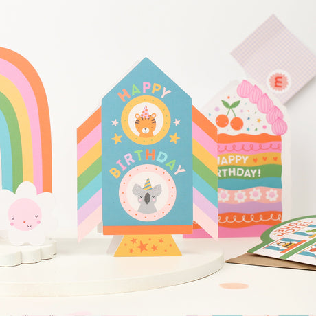 Colorful childrens Rocket birthday cards with animal illustrations on a white background