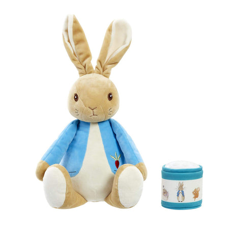 Peter Rabbit soft toy with with small container on a white background