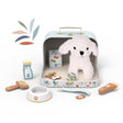 A children's pretend pet-care playset arranged on a white background. The set includes a small open case with a plush white dog inside, plus accessories such as a bowl, brush, treats, bandage, and a clipper.