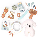 Collection of pet care products including a plush dog toy, grooming tools, and accessories on a white background.