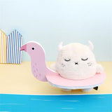 Flamingo-shaped pool float with a plush toy on a blue surface
