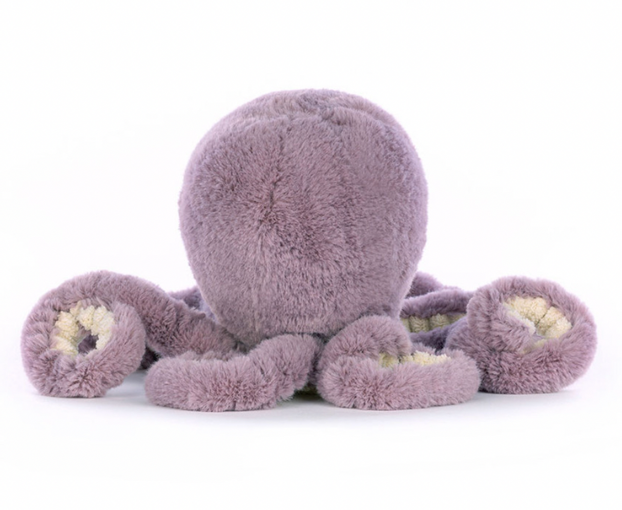A plush toy resembling an octopus with a smiling face, made of soft purple fabric,