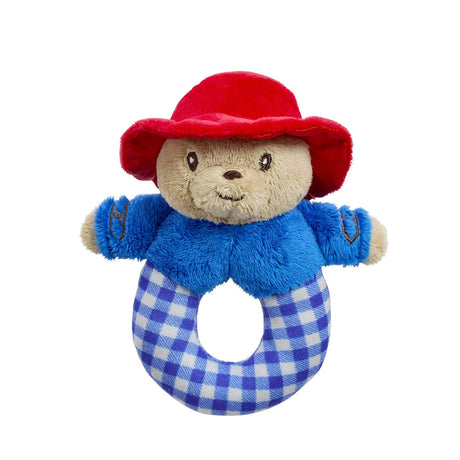 Soft Paddington toy with a red hat and blue checkered ring rattle on a white background