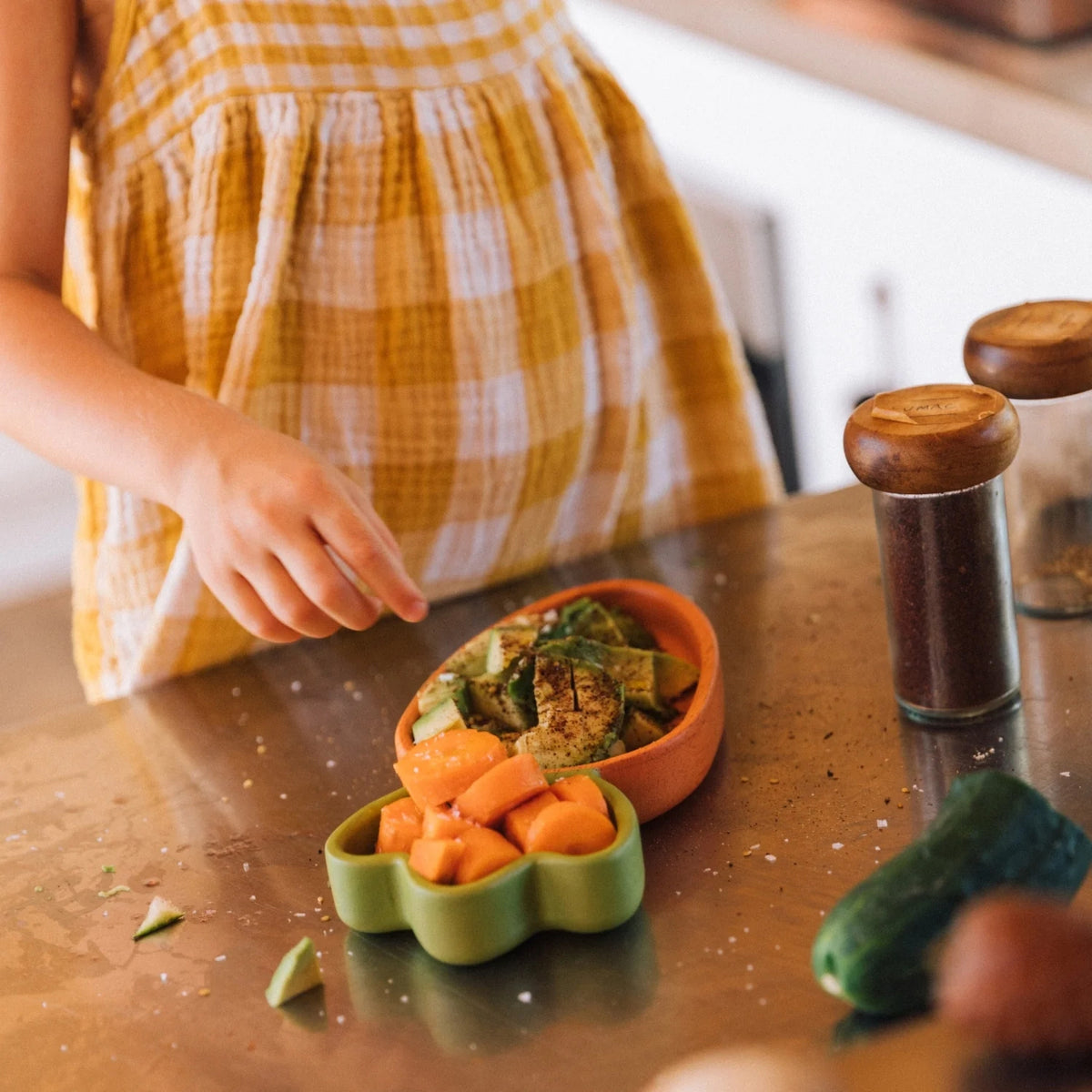 Cathy the Carrot plate by Oli & Carol in natural Hevea wood with veg in being used by a child 