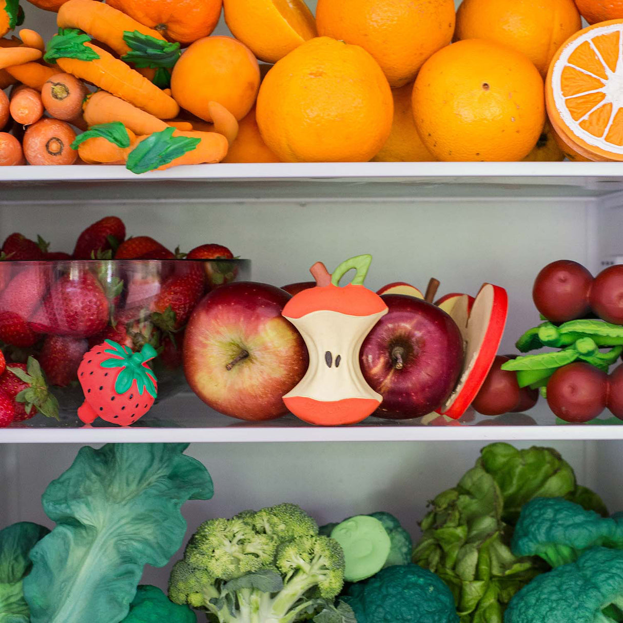 Shelves with bright read and toy fruits, vegetables.