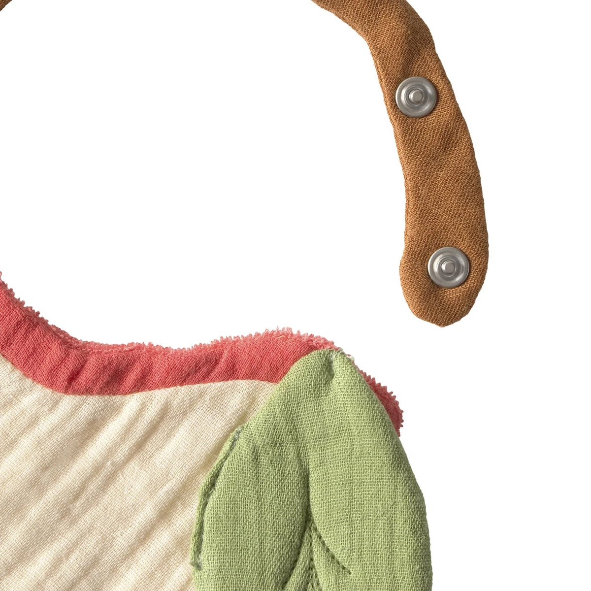 Close-up of the snap fastener and stem strap on the Oli & Carol Pepa The Apple Bib, showing the adjustable neck fitting