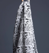 Organic Muslin Swaddle Wild Animals from  wee Gallery hanging with a dark grey background