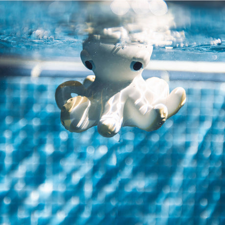 White rubber octopus floating in blue water