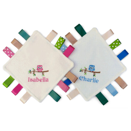 Two soft baby owl design taggy comforters with embroidered names 'Isabella' and 'Charlie', surrounded by colourful tags.
