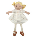 Stuffed doll with blonde hair, wearing a white dress with flower patterns and brown shoes on a white background.