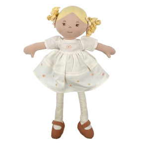 Stuffed doll with blonde hair, wearing a white dress with flower patterns and brown shoes on a white background.