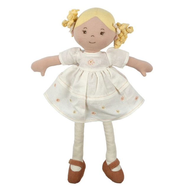Stuffed doll with blonde hair, wearing a white dress with flower patterns and brown shoes on a white background.