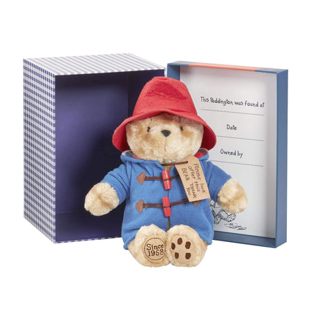 Paddington bear toy with red hat and blue coat in a gift box