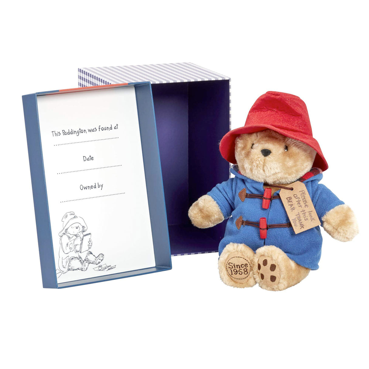 Plush Paddington bear toy with a red hat and blue coat next to a certificate in a blue box on a white background.