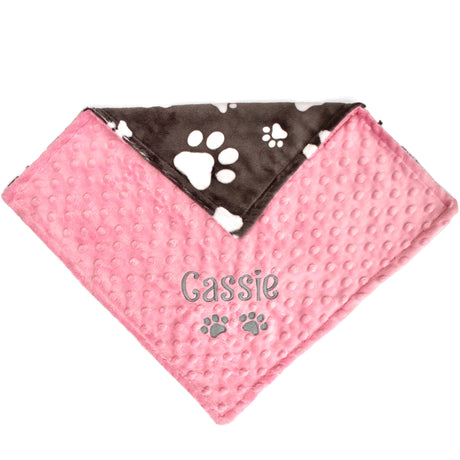 Pink and slate grey pet blanket with paw prints and the name embroidered