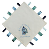 A personalised cream-coloured baby sensory lovey blanket with embroidered text and a cartoon eeyore character, surrounded by colourful ribbons on the edges.