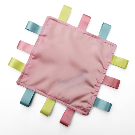 A square pink satin fabric sensory baby comforter with 12 colourful satin ribbon tabs radiating from the edges, shown on a plain white background.