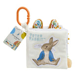 Rainbow Designs Peter Rabbit fold out soft activity book with orange clip, fluffy ears tabs and Peter Rabbit appliqué on white corduroy cover, on a white background