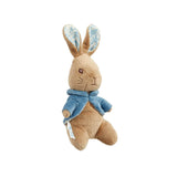 Stuffed small Peter rabbit toy with a blue jacket on a white background