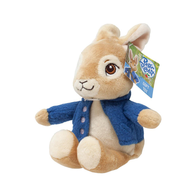 Soft toy Peter Rabbit in a blue coat with a tag on a white background