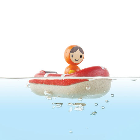 Toy figure in a red boat floating on water