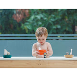 Child playing with toys in a bathtub outdoors