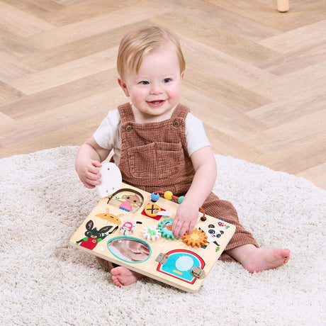 Child playing with a wooden Bing puzzle toy on a carpeted floor.