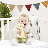 Baby sitting in a crib holding a Plush baby toy of a lion cub Simba from Disney's 'The Lion King' with green teether leaf attached with a colourful banner in the background