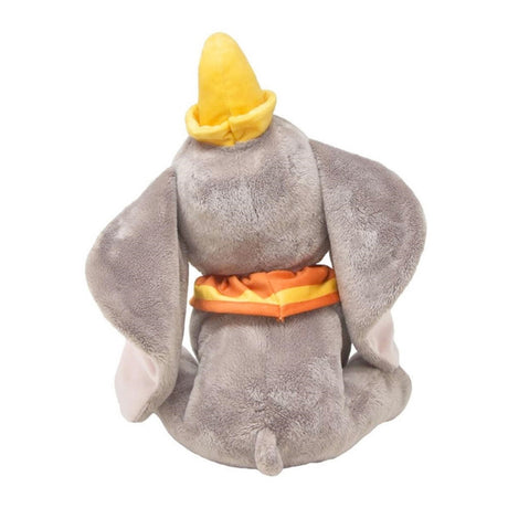 Plush Dumbo toy of a character with a yellow hat and orange bandana on a white background