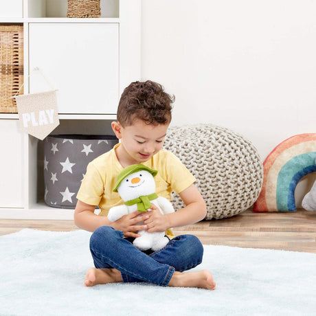 Child holding a plush snowman toy in a playroom setting