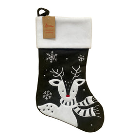 Black Christmas stocking with white reindeer design on a white background