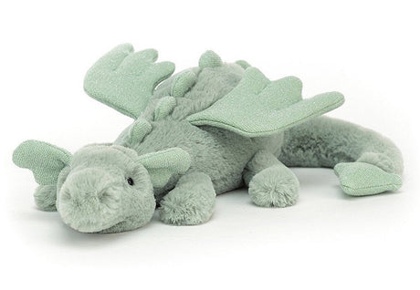 A plush toy depicting a sage green dragon with soft fur, sparkly wings, and a long tail.
