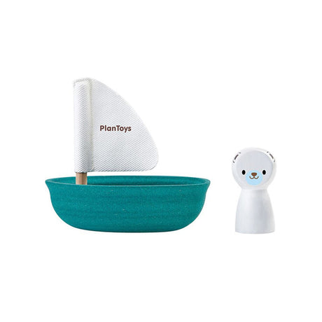 Teal toy boat with white sail and bear figure on a white background, featuring PlanToys branding.