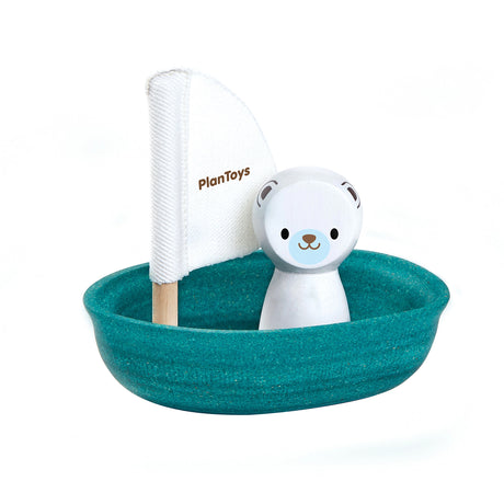 Toy boat with a polar bear figure and a white sail, branded 'PlanToys', on a white background.