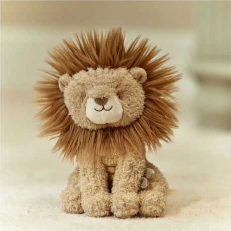 Plush lion toy with a soft texture on a beige background