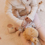 A close-up lifestyle shot of a child playing with baby soft doll Julia