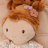 Close-up of Little Dutch Cuddle Doll Ava with a round beige face, embroidered brown eyes and a small smile