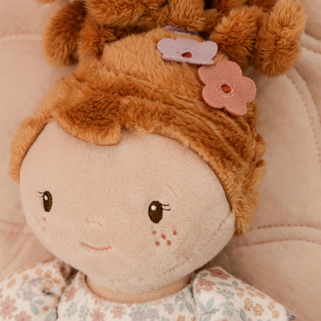 Close-up of Little Dutch Cuddle Doll Ava with a round beige face, embroidered brown eyes and a small smile