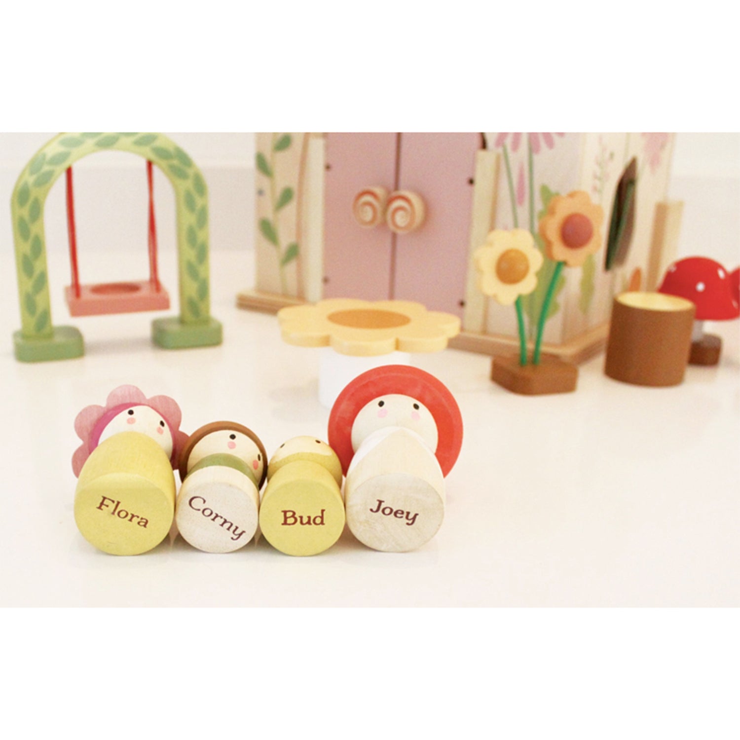 Set of wooden toy figures with names on a white background