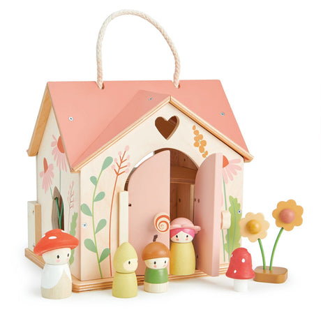 The house is adorned on every side with vibrant wildflower decorations, and two cleverly placed windows allow flower stems to seemingly grow right through the walls, creating a whimsical woodland meadow effect.