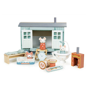 Wooden toy set with a small house and various animal figures on a white background
