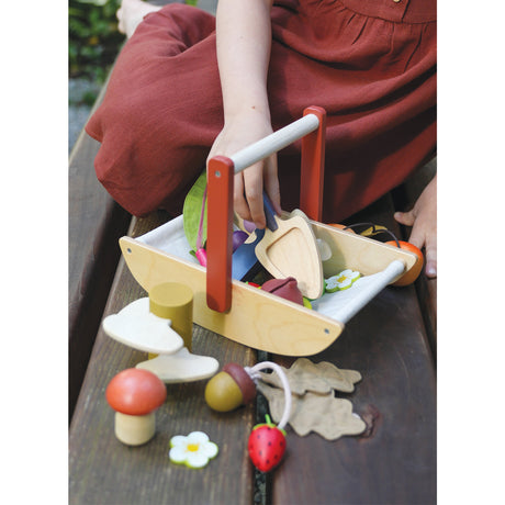 Child playing with wooden toys on a wooden surface