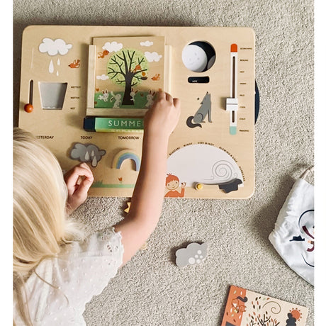 Child playing with a wooden educational toy on a carpeted floor