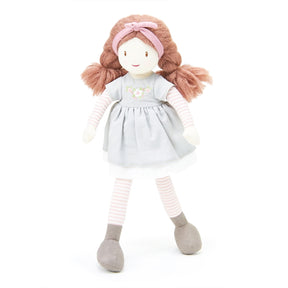 Plush rag doll with pink hair, gray dress, and striped socks on a white background