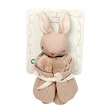 Beige knitted bunny with pom-poms on a white background